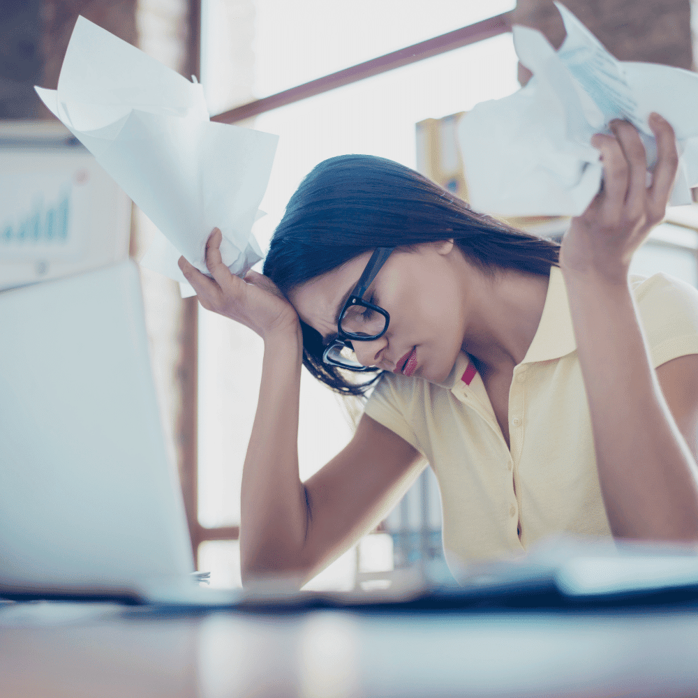 Woman struggling with paperwork Woman struggling with paperwork