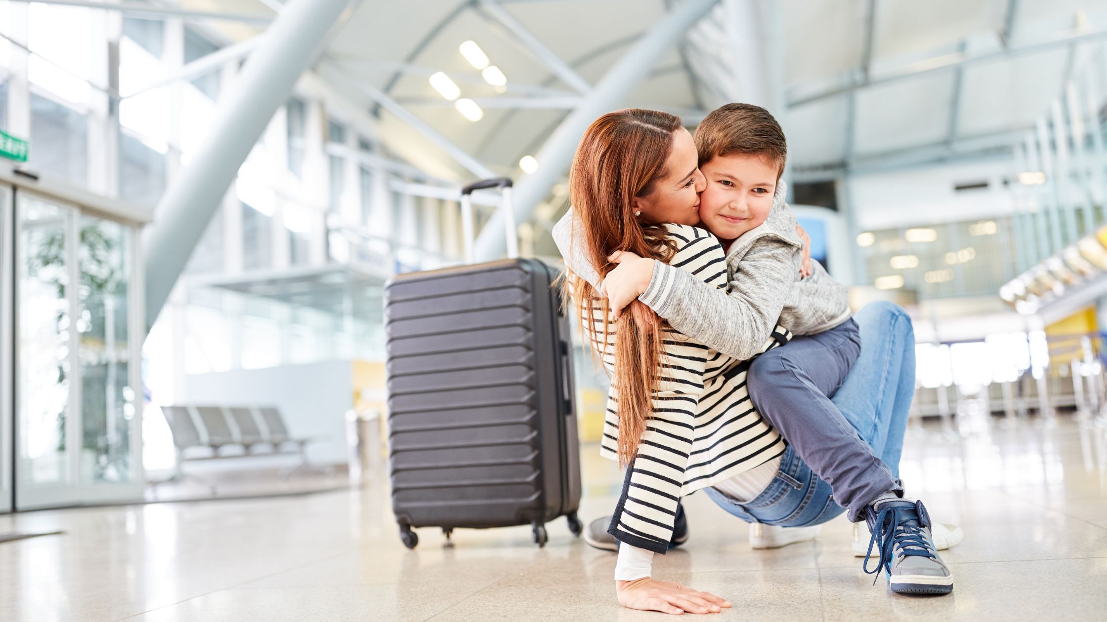 A separated parent preparing travel documents and passport to take their child abroad after divorce, following UK legal rules and permission requirements.