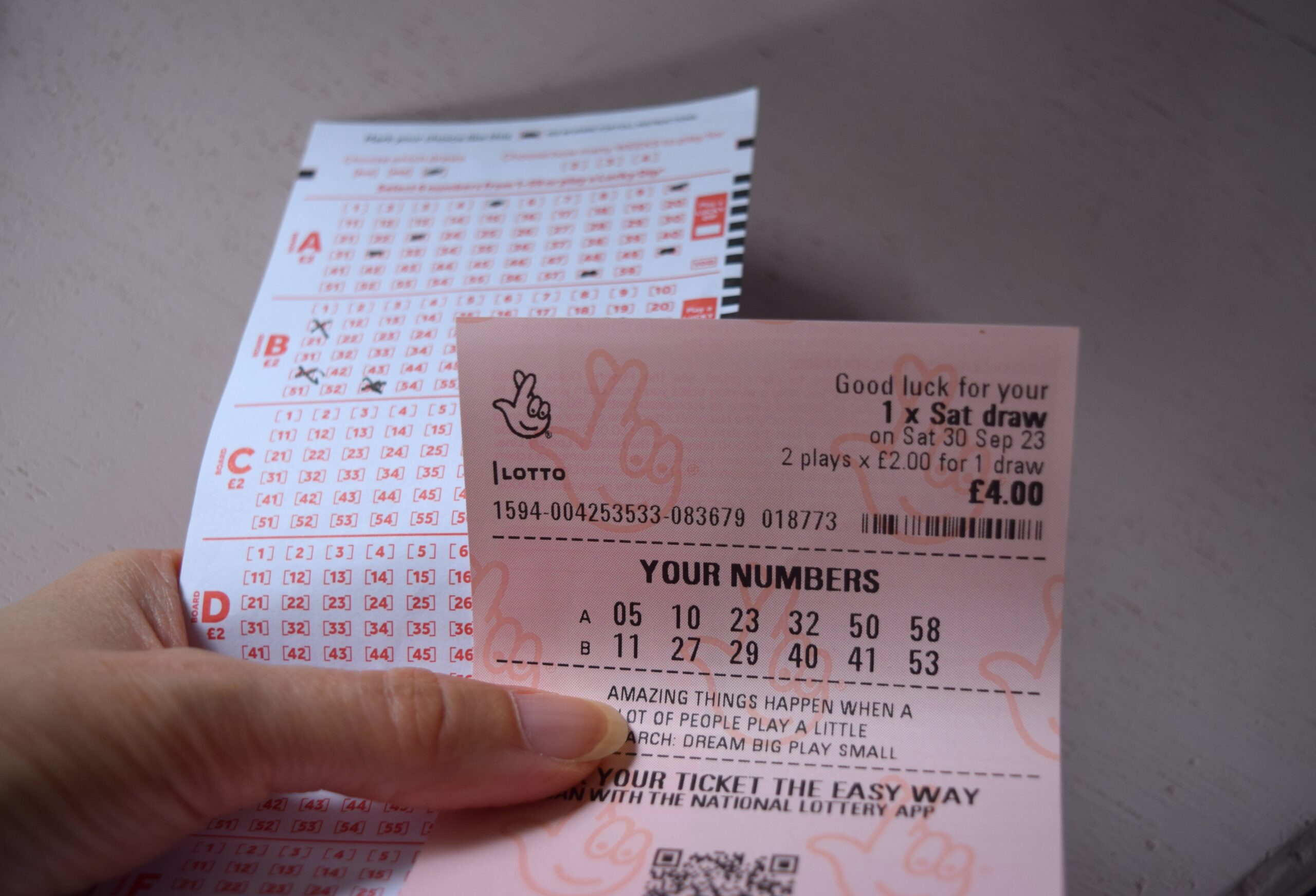 Hand holding a lottery ticket after divorce